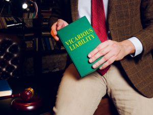 lawyer holding a book of vicarious liability