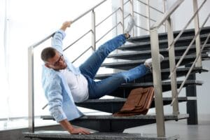 Man falling on stairs in building. Dangerous accident